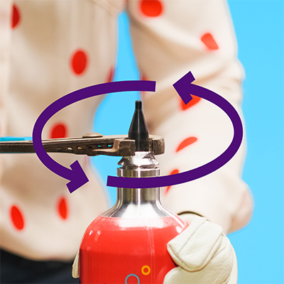 Arrows pointing counter-clockwise around Mini Helium Tank nozzle